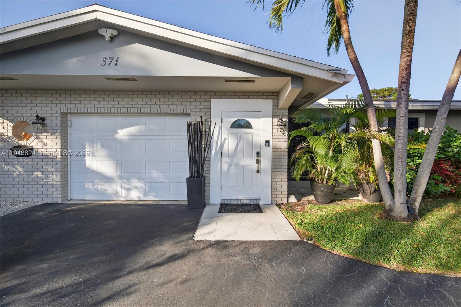 371 Southeast 3rd Street Pompano Beach, FL 33060 - Photo 20 of 87 a front view of a house with a yard