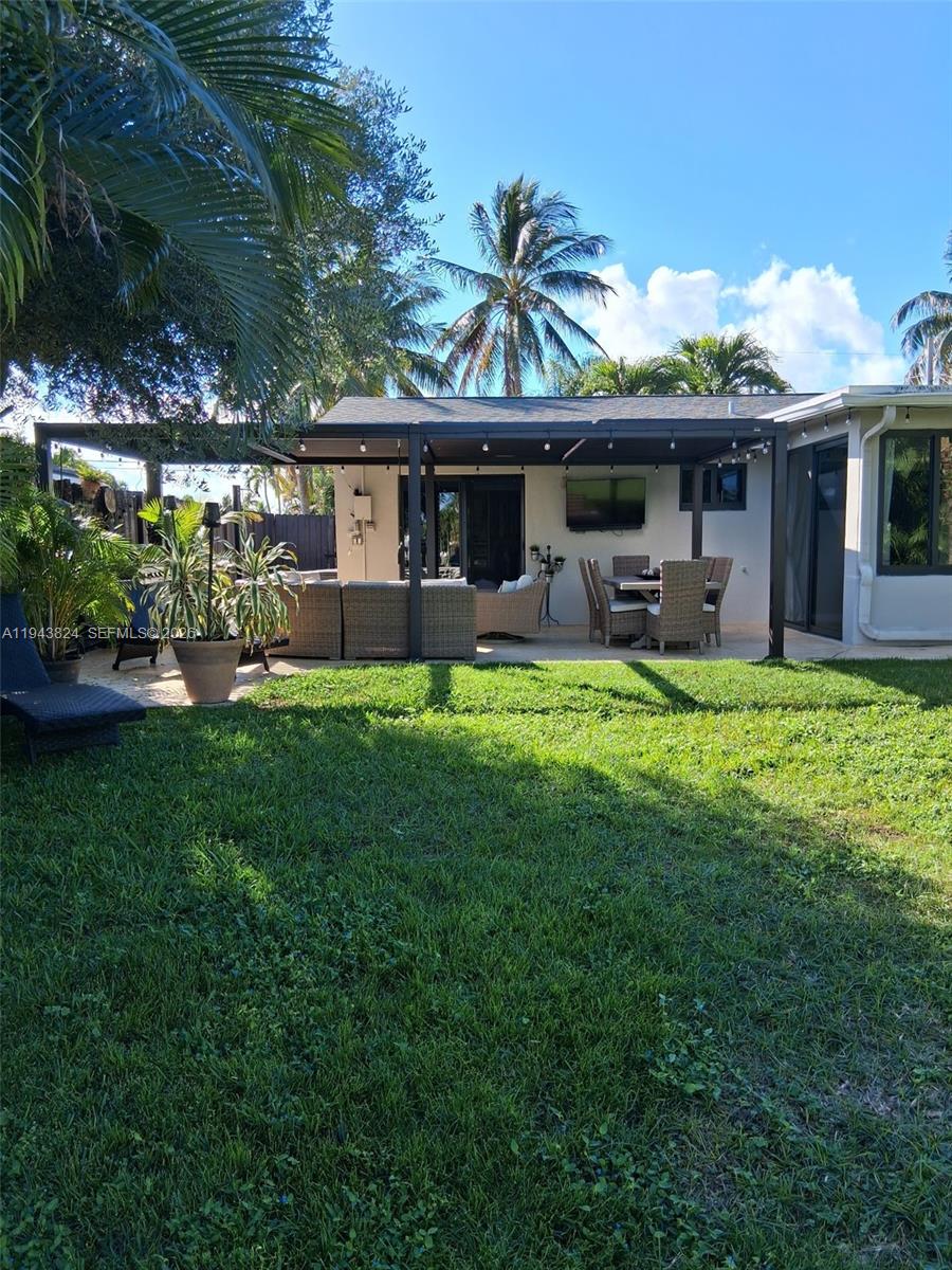 371 Southeast 3rd Street Pompano Beach, FL 33060 - Photo 76 of 87 a view of a house with backyard porch and sitting area