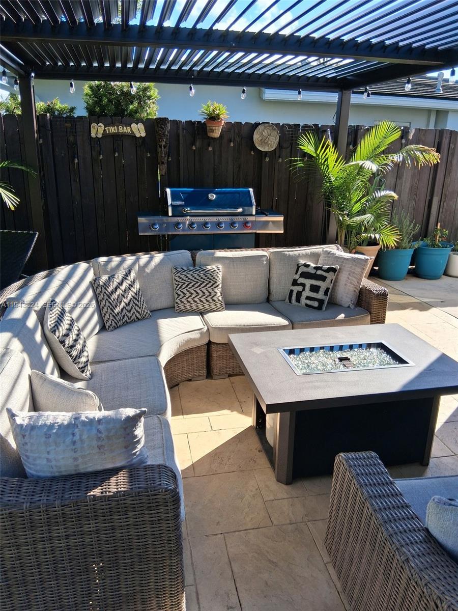 371 Southeast 3rd Street Pompano Beach, FL 33060 - Photo 77 of 87 a view of a patio with a table and chairs