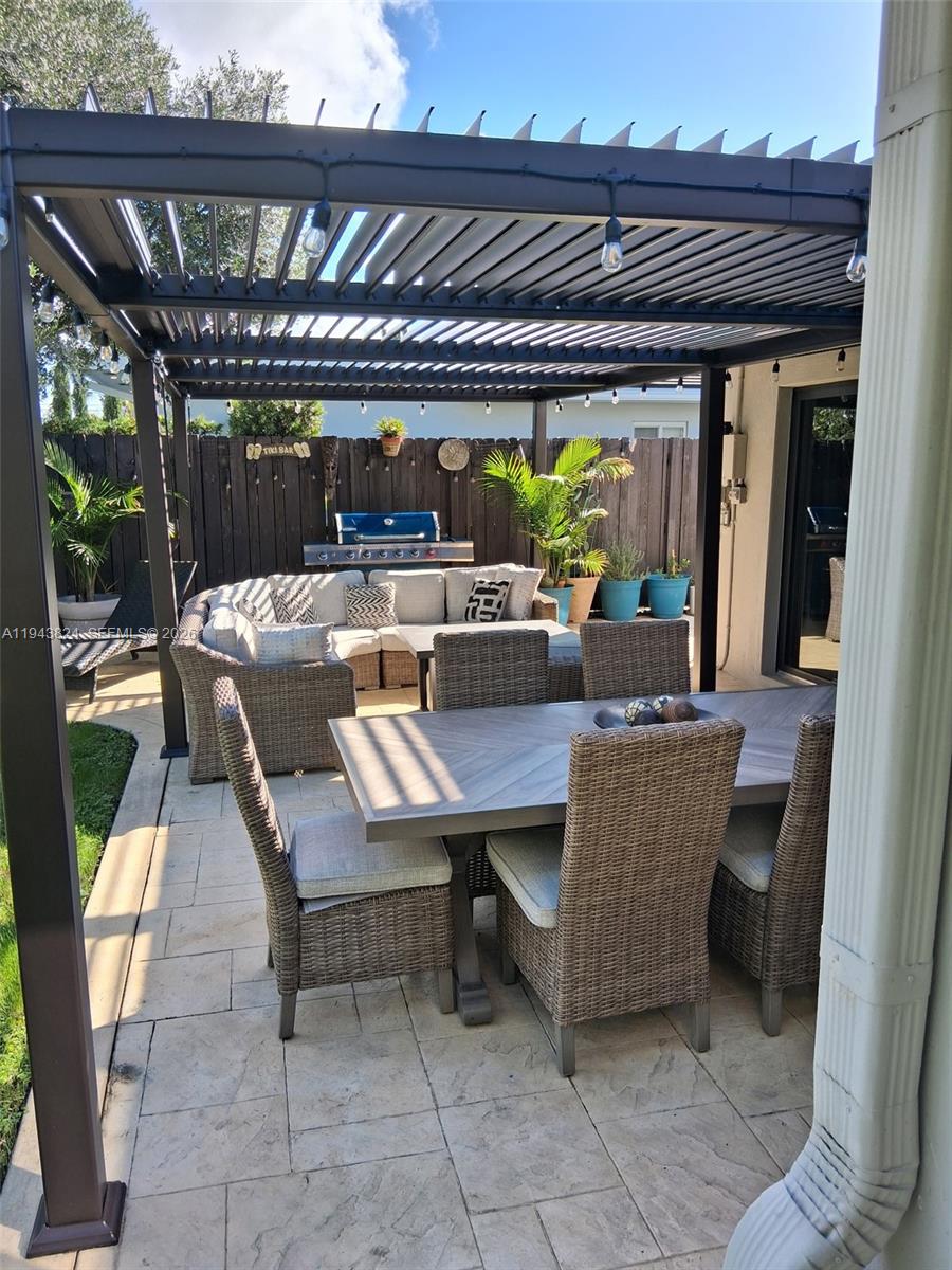 371 Southeast 3rd Street Pompano Beach, FL 33060 - Photo 78 of 87 a view of a patio with a table chairs and a potted plant