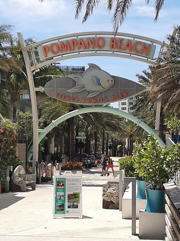 371 Southeast 3rd Street Pompano Beach, FL 33060 - Photo 85 of 87 a view of a patio with table and chairs under an umbrella