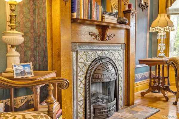 a view of living room with furniture and a fireplace