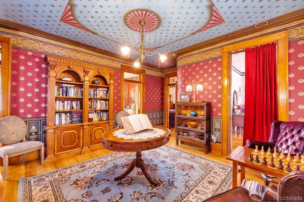 a living room with furniture and a chandelier