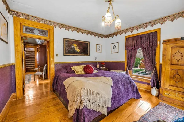 a bedroom with a bed and a chandelier