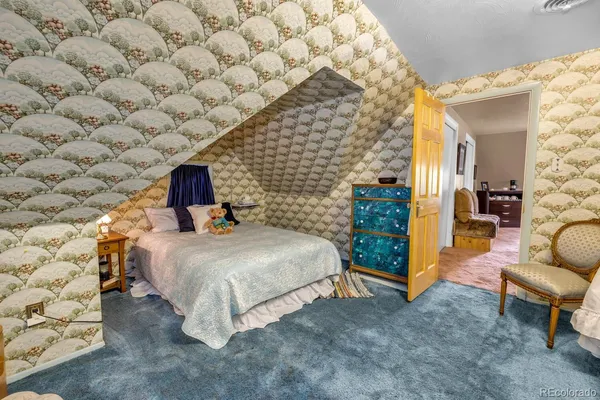 a bedroom with a bed and a couch