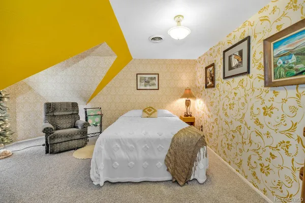 a bedroom with a bed and a couch