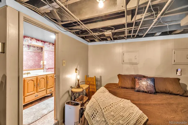 a bed room with a bed and next to a window