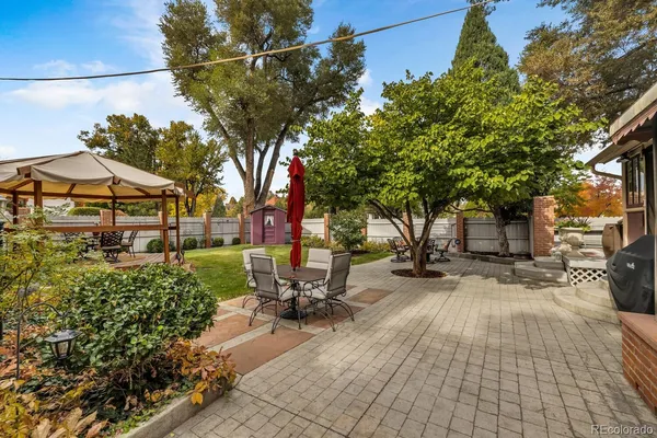a view of a backyard with sitting area