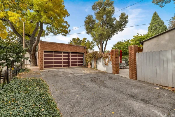 front view of a house with a yard and potted plants