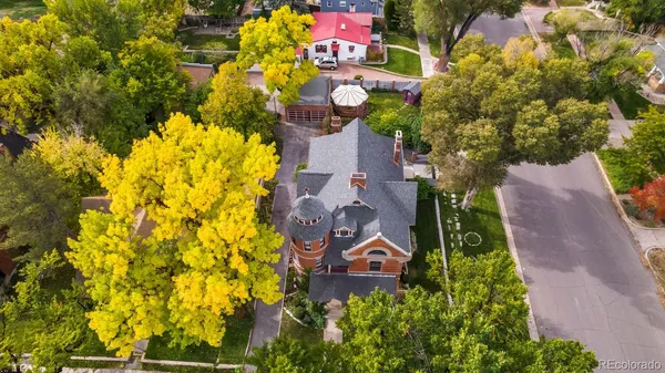 a aerial view of a house with a yard and garden