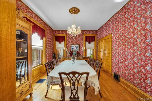 a view of a dining room with furniture and a chandelier