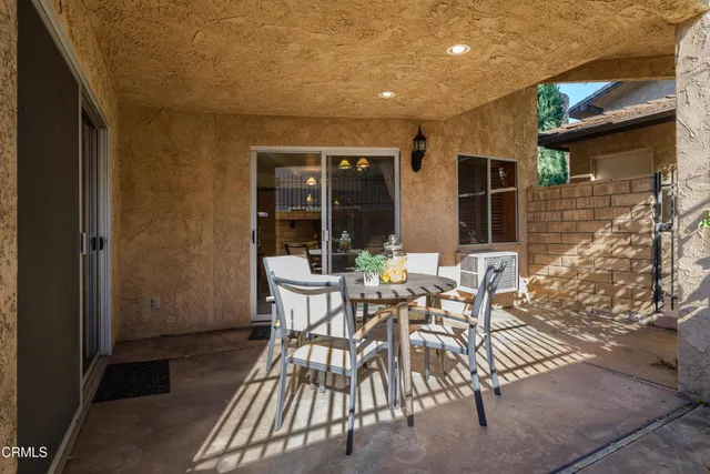 a view of a patio with table and chairs and potted plants