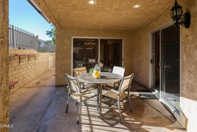 a view of a patio with table and chairs and potted plants