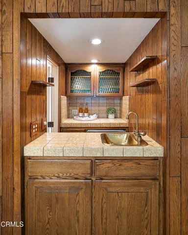 a kitchen with a sink and a refrigerator