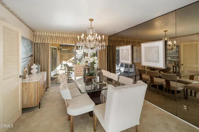 a large living room with furniture and chandelier