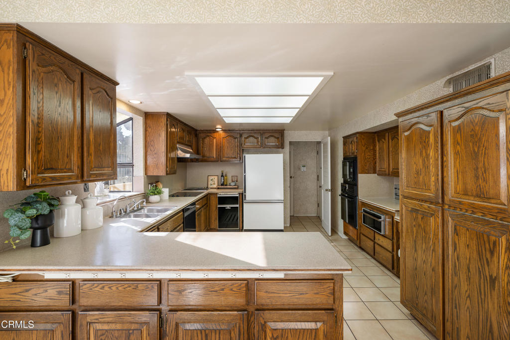 1400 Valley View Road, Unit 1 Glendale, CA 91202 - Photo 23 of 52 a kitchen with kitchen island a counter top space a sink stainless steel appliances and cabinets