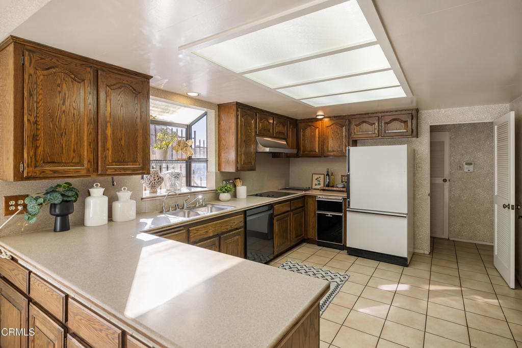 1400 Valley View Road, Unit 1 Glendale, CA 91202 - Photo 24 of 52 a kitchen with a sink a refrigerator and cabinets