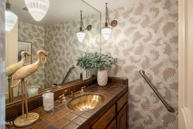 a bathroom with a granite countertop sink a toilet and mirror