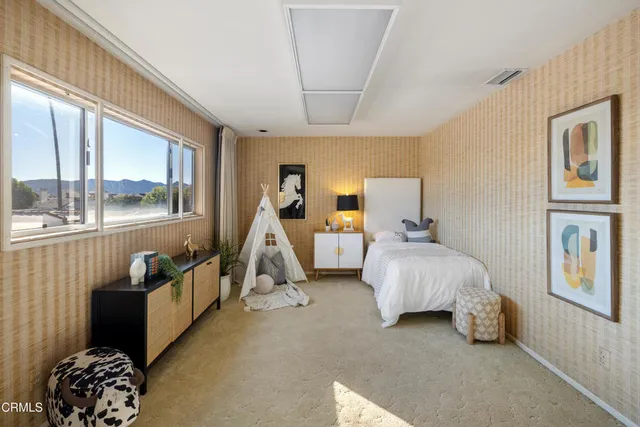 a bed room with a bed and a large window