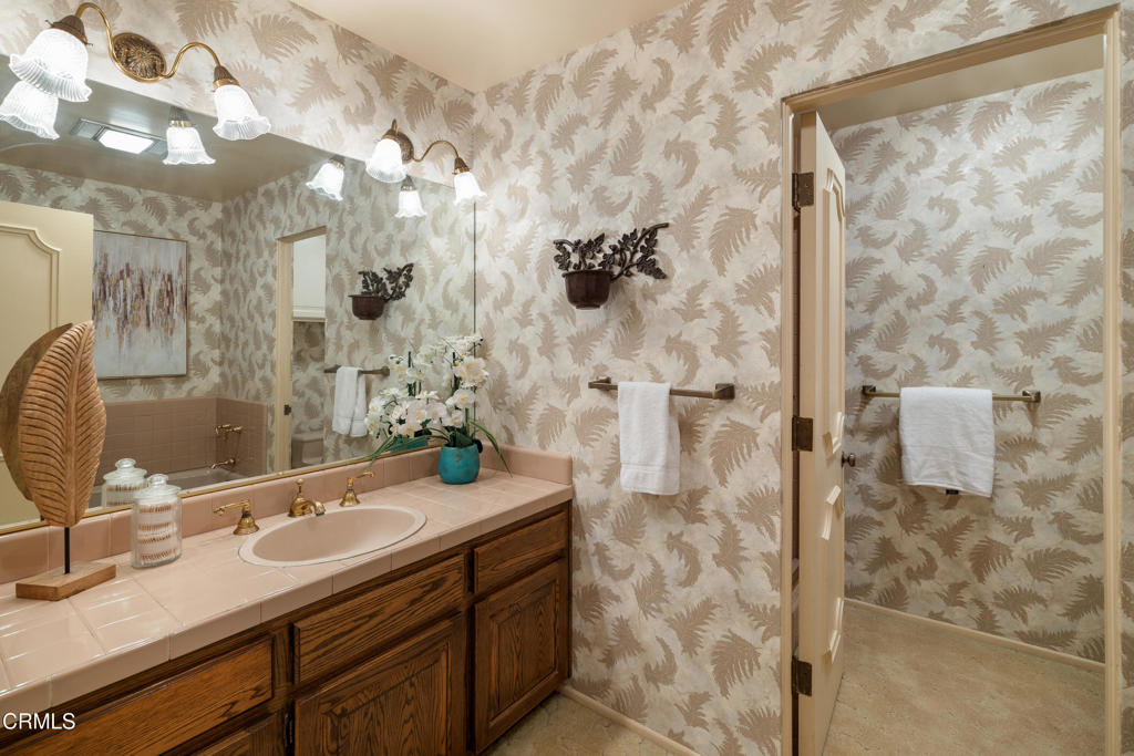 1400 Valley View Road, Unit 1 Glendale, CA 91202 - Photo 42 of 52 a bathroom with a granite countertop sink a mirror and shower