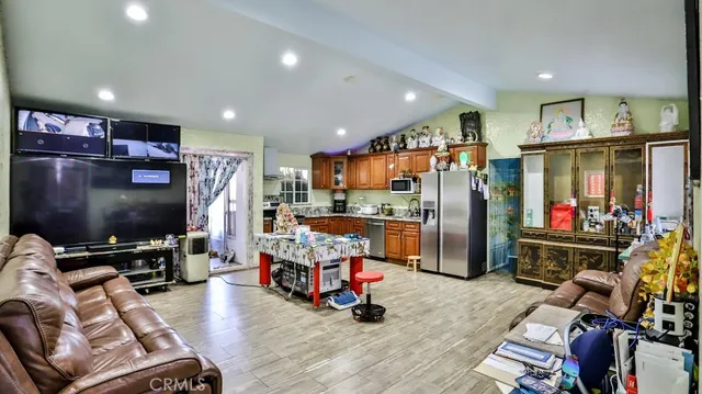 a view of a room with gym equipment and a flat screen tv