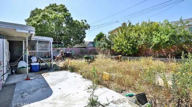 a view of a backyard with plants and outdoor seating