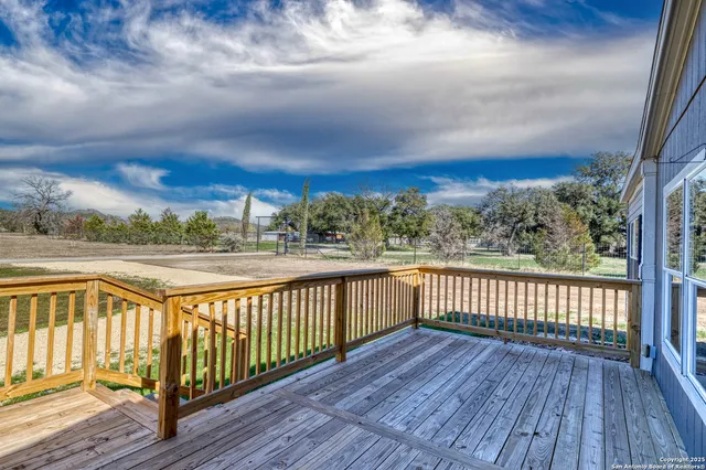 a view of a balcony with wooden floor