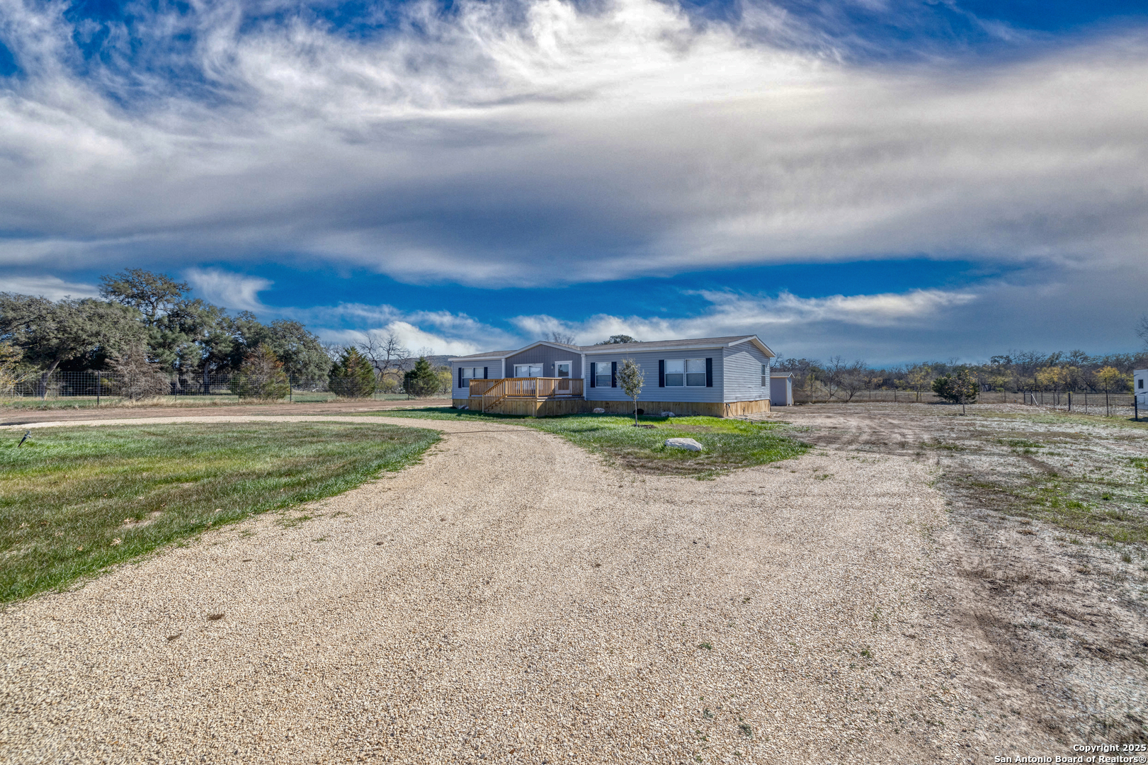 130 River Vly Road Rio Frio, TX 78879 - Photo 2 of 28 a view of a big yard with palm trees
