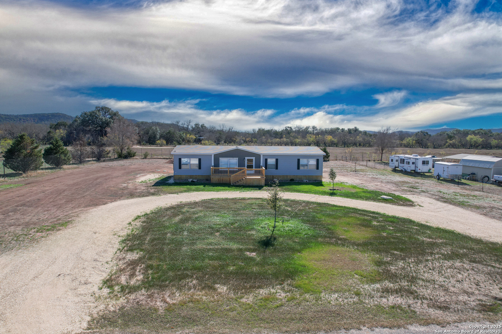 130 River Vly Road Rio Frio, TX 78879 - Photo 22 of 28 a aerial view of a house with a garden