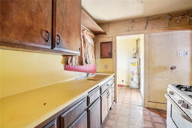 a utility room with stainless steel appliances a stove and a refrigerator