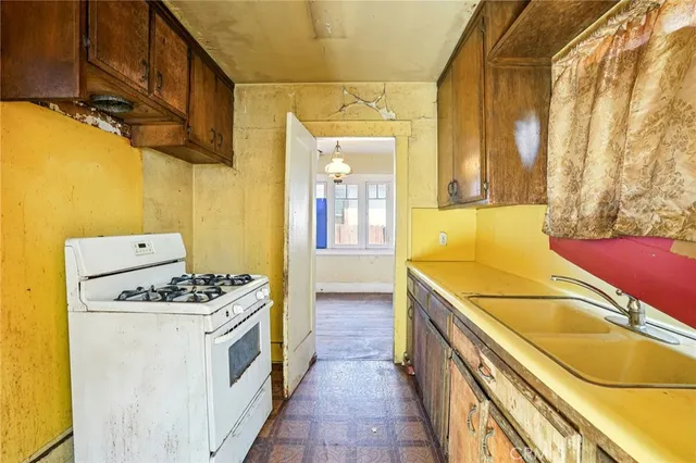 a kitchen with stainless steel appliances granite countertop a sink and a stove