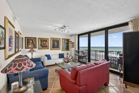 a living room with furniture and a floor to ceiling window