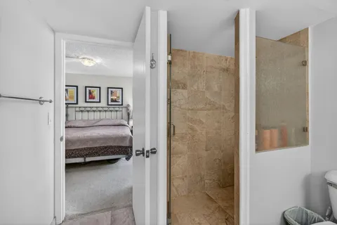 a bedroom with two beds and a lamp on table
