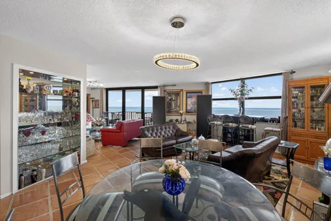 a living room with furniture and a floor to ceiling window
