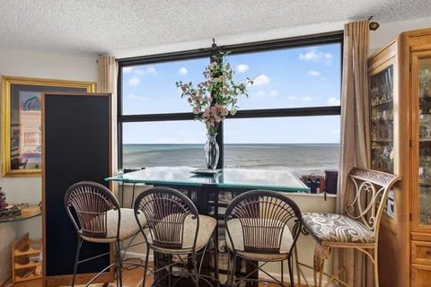 a dining room with furniture and window