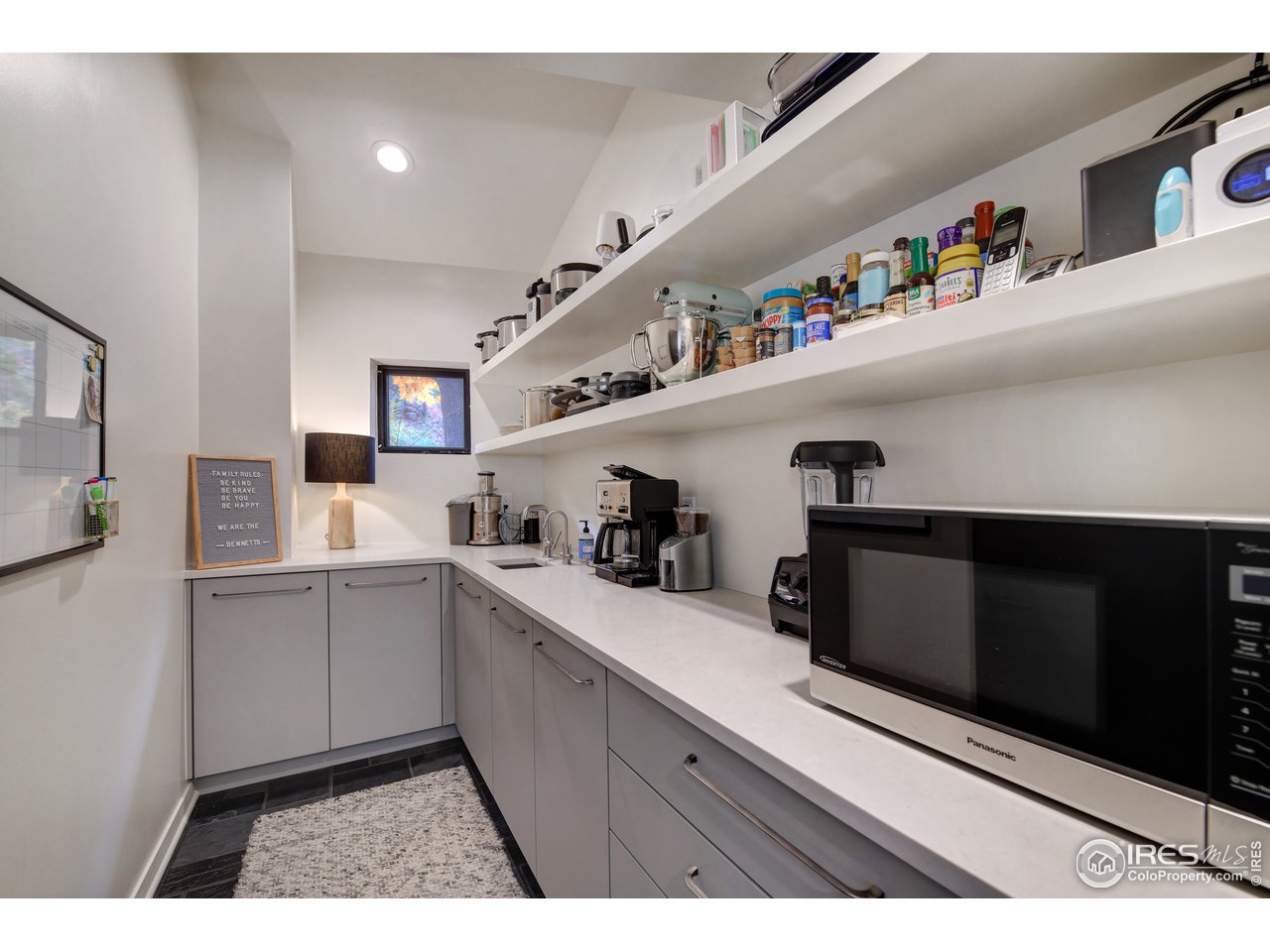 505 Geneva Avenue Boulder, CO 80302 - Photo 9 of 40 a kitchen with stainless steel appliances a sink and cabinets