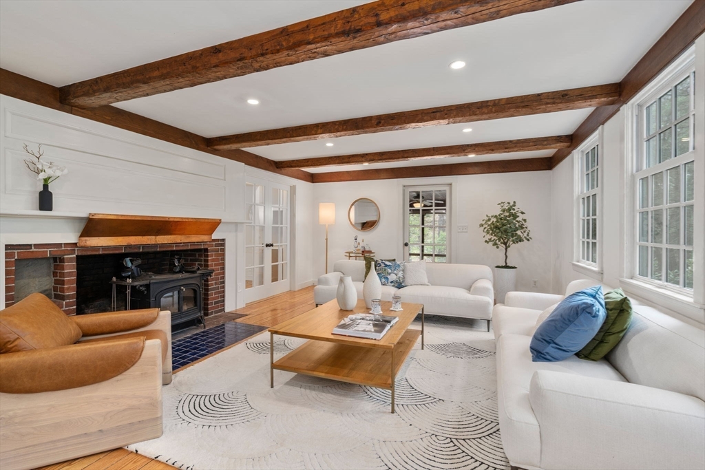 8 Todd Pond Road Lincoln, MA 01773 - Photo 11 of 29 a living room with fireplace furniture and a floor to ceiling window