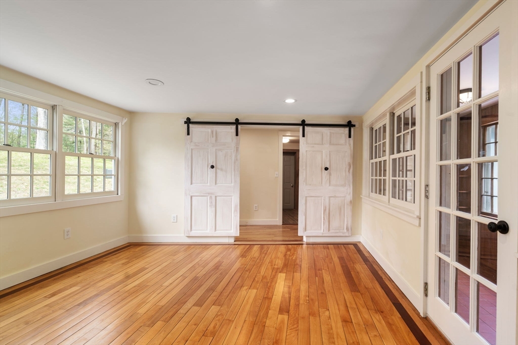 8 Todd Pond Road Lincoln, MA 01773 - Photo 4 of 29 a view of an empty room with wooden floor and windows