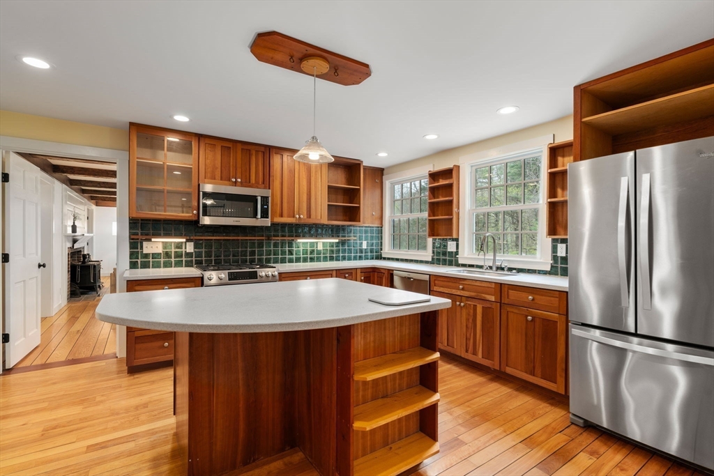 8 Todd Pond Road Lincoln, MA 01773 - Photo 6 of 29 a kitchen with stainless steel appliances granite countertop a sink a stove a refrigerator and island with wooden floor