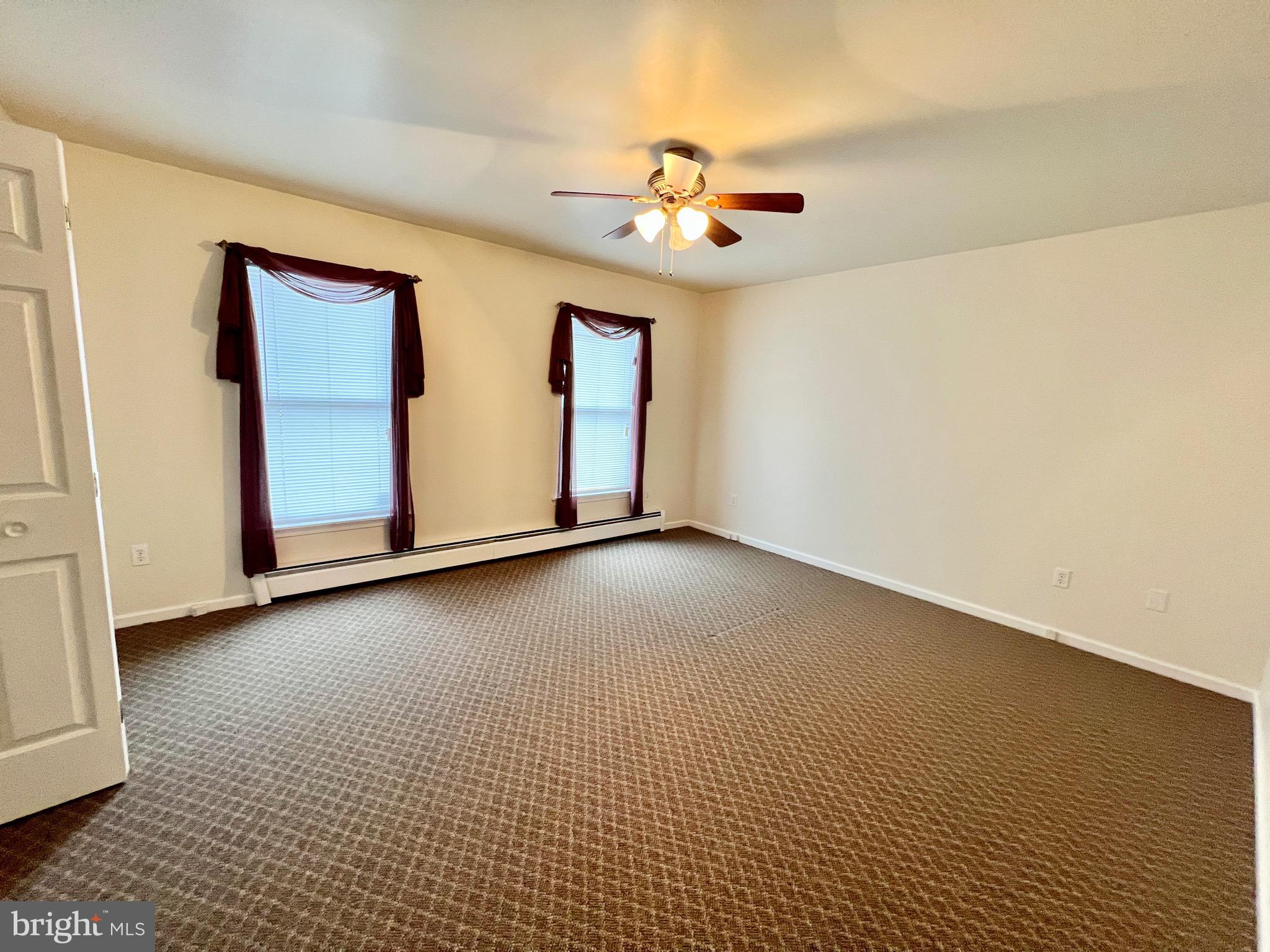 107 Centre Street Ashland, PA 17921 - Photo 11 of 32 a view of a livingroom with a ceiling fan and window