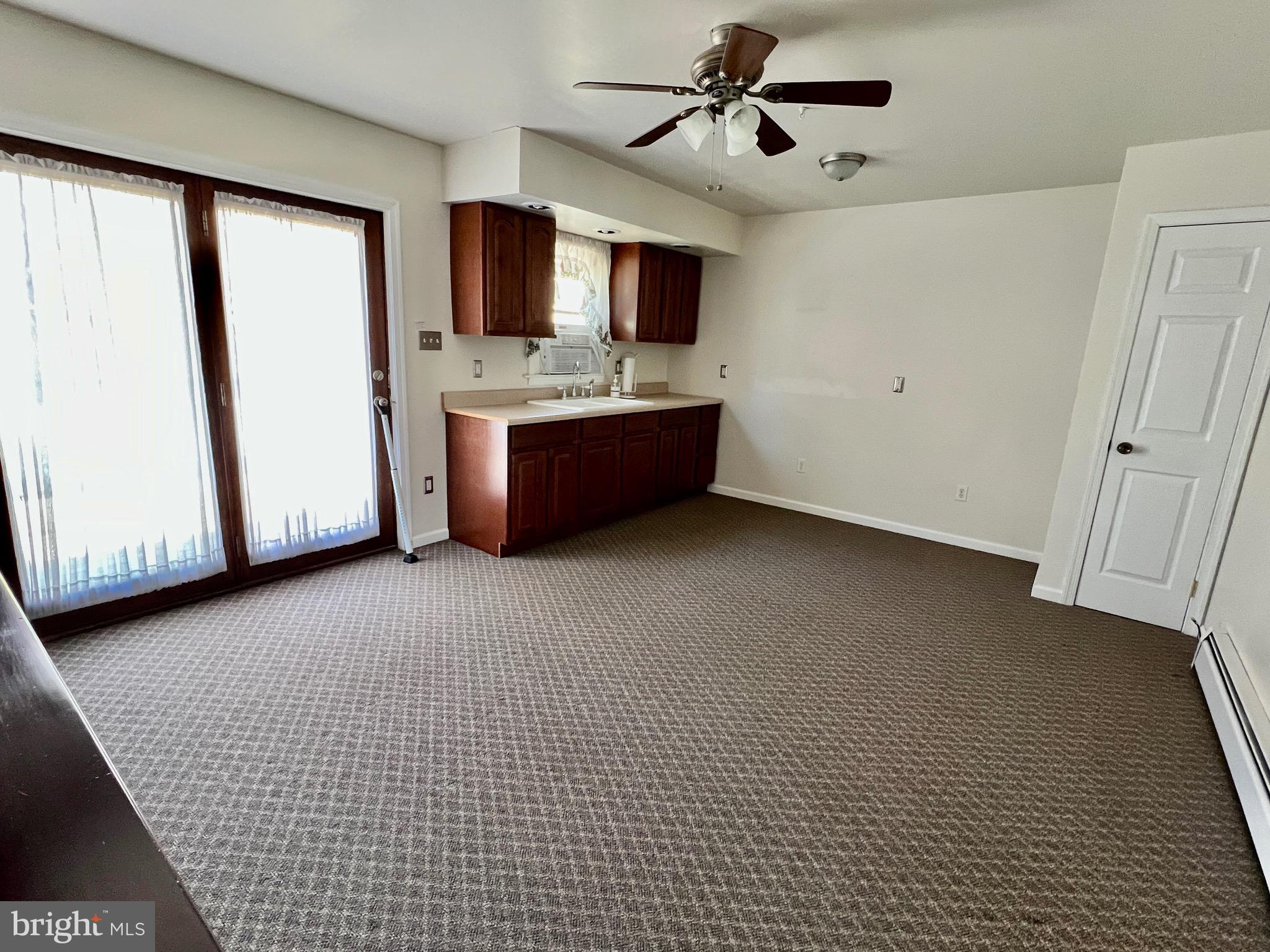 107 Centre Street Ashland, PA 17921 - Photo 8 of 32 a living room with stainless steel appliances kitchen island granite countertop furniture and a flat screen tv