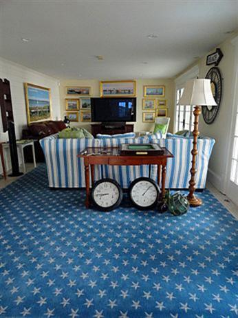 66 Tern Lane Centerville, MA 02632 - Photo 10 of 11 a living room with furniture a flat screen tv and a fireplace