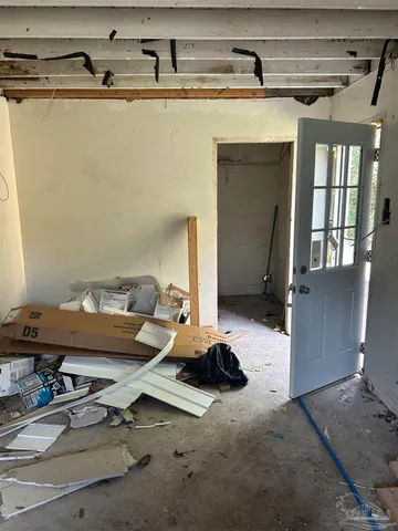 a room with gym equipment and wooden floor