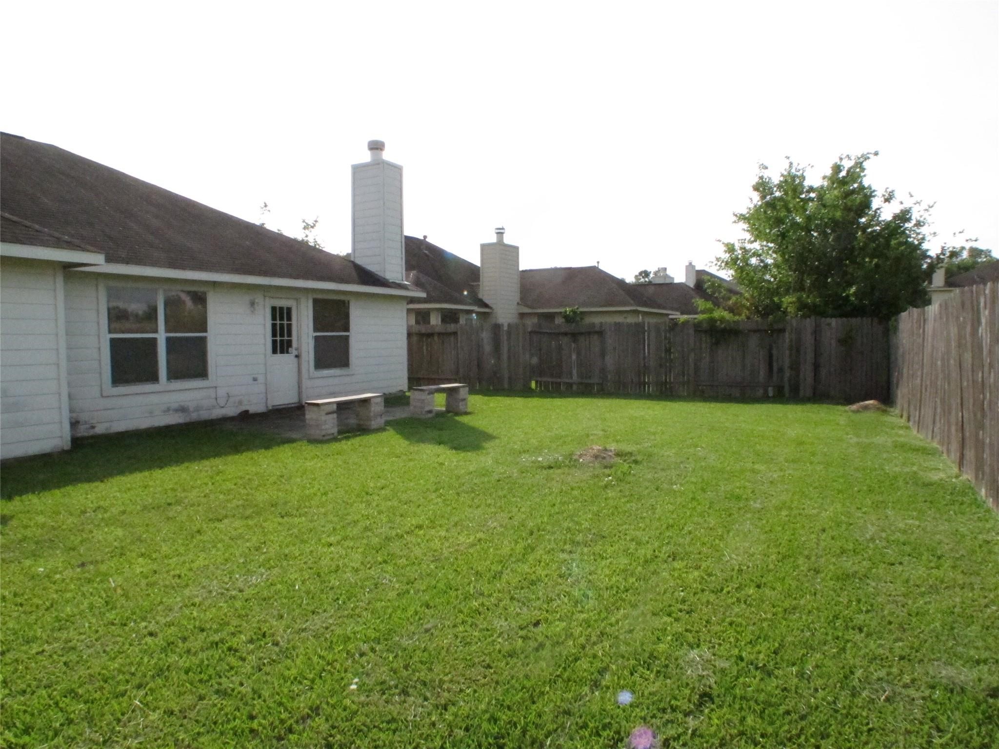 24022 Rockygate Drive Spring, TX 77373 - Photo 12 of 12 a view of a house with a yard and wooden fence