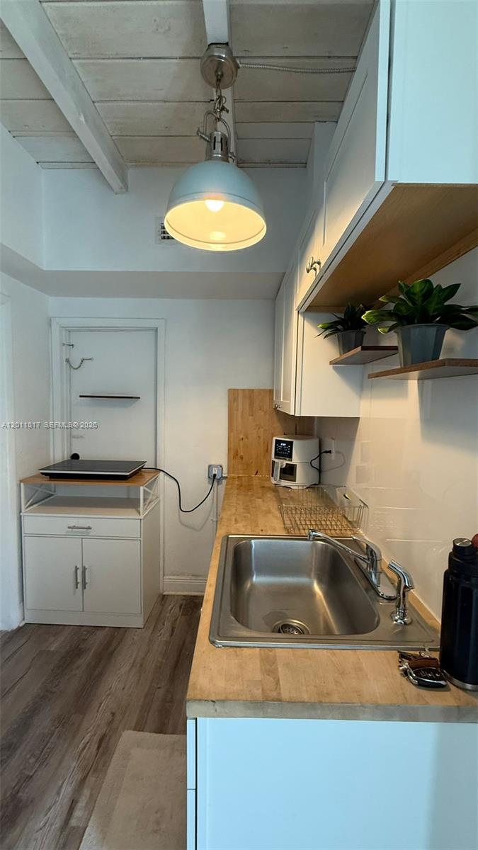 115 Southeast 2nd Street, Unit 2 Dania Beach, FL 33004 - Photo 5 of 11 a kitchen with a sink and a stove