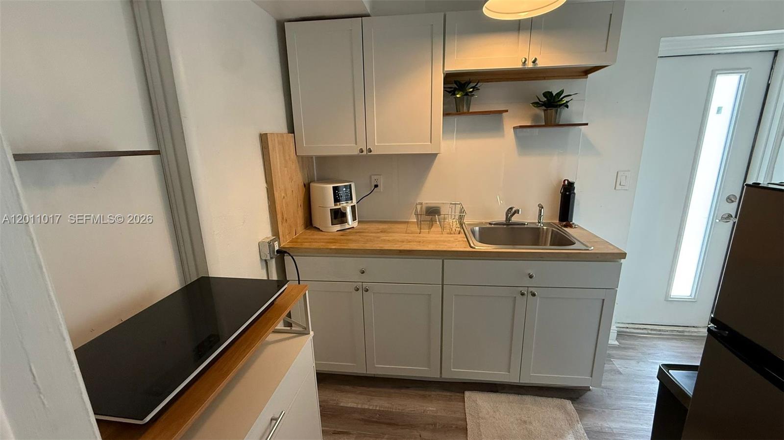 115 Southeast 2nd Street, Unit 2 Dania Beach, FL 33004 - Photo 6 of 11 a kitchen with sink cabinets and appliances