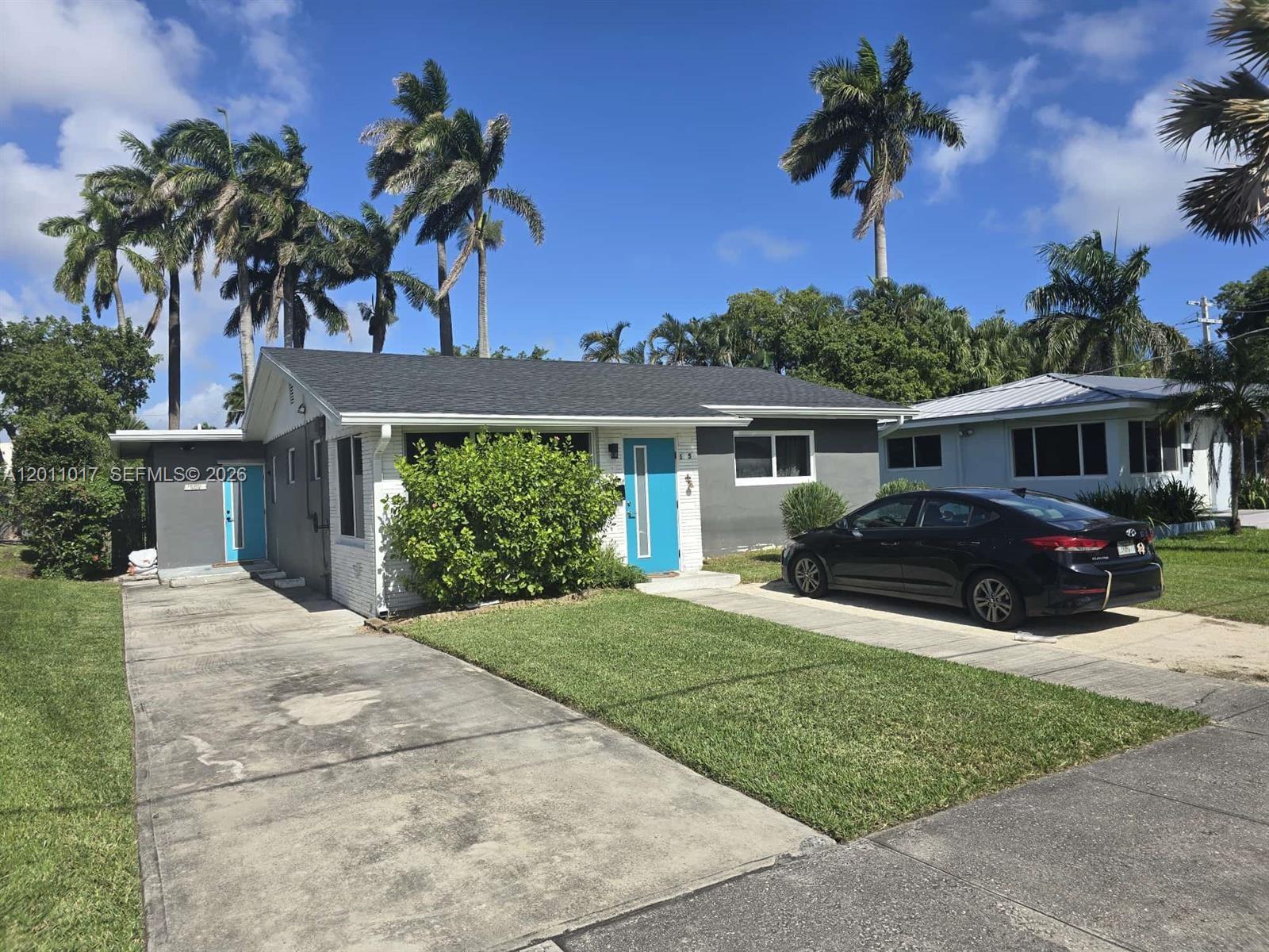 115 Southeast 2nd Street, Unit 2 Dania Beach, FL 33004 - Photo 9 of 11 a house view with a garden space
