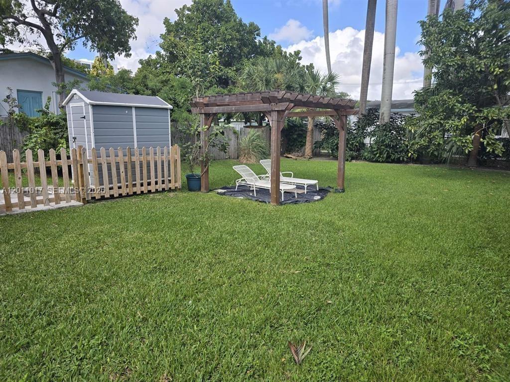 115 Southeast 2nd Street, Unit 2 Dania Beach, FL 33004 - Photo 10 of 11 a view of a chair and table in backyard of the house