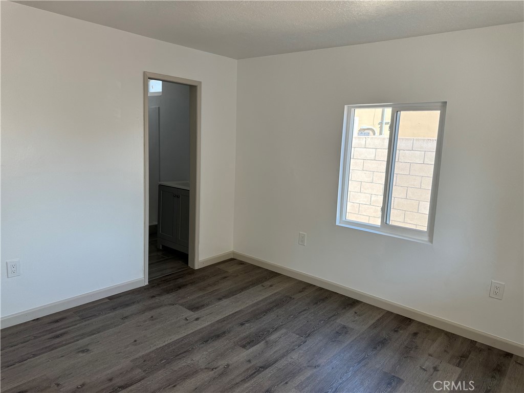 5263 35th Street Jurupa Valley, CA 92509 - Photo 18 of 19 an empty room with wooden floor and windows