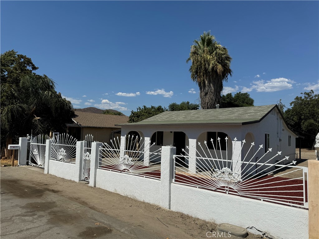 5263 35th Street Jurupa Valley, CA 92509 - Photo 2 of 19 a view of a patio with table and chairs with wooden floor and fence